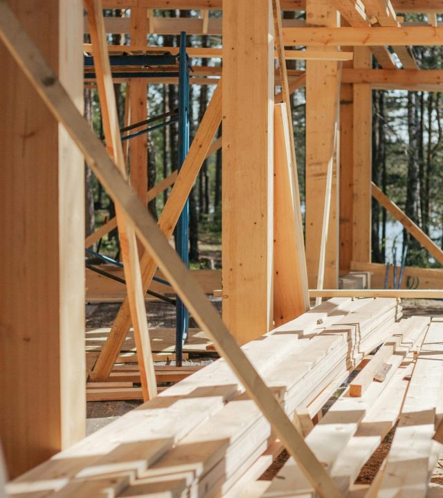 pexels photo 8817838 8817838 Sunlit construction site with wooden lumber arranged in rows. Perfect for building projects.